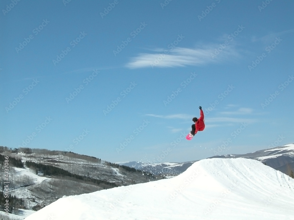 Snowboarder high in the air jumping