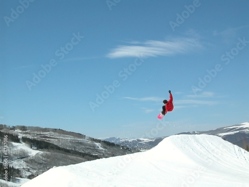 Snowboarder high in the air jumping