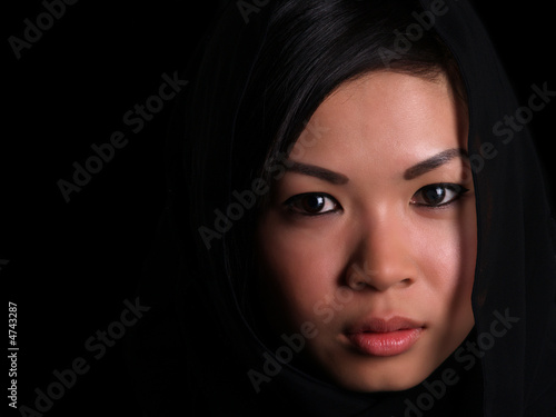Beautiful Asian shy looking girl (with copy space)
