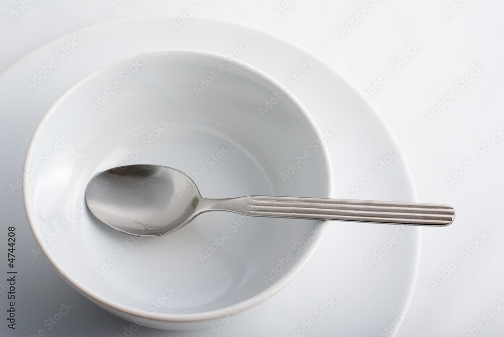 white porcelain set of plate and bowl with spoon inside white porcelain set of plate and bowl with spoon inside