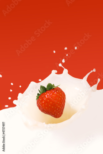 strawberry splashing in milk