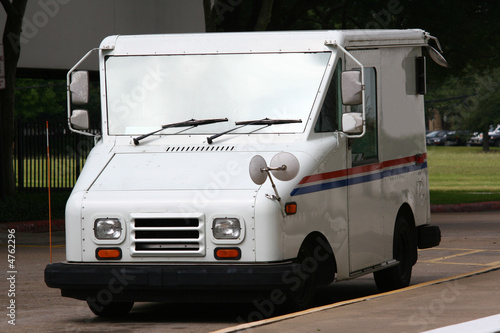 White Mail Truck Delivering Mail photo
