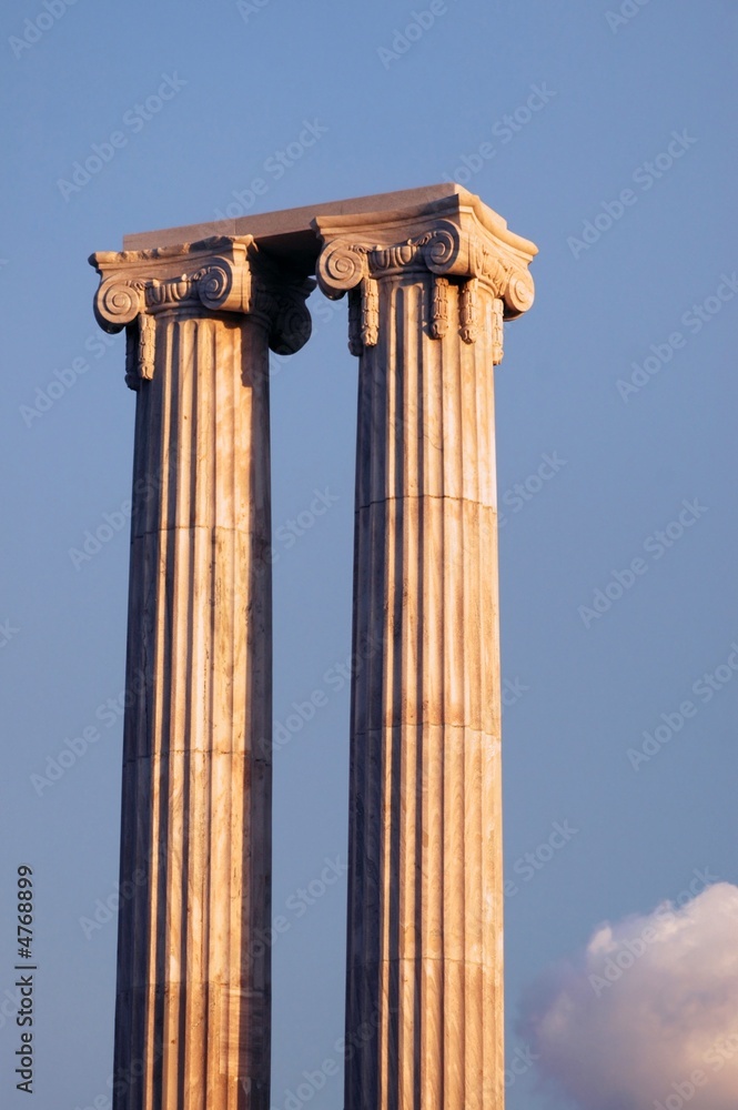 Two greek columns against blue sky