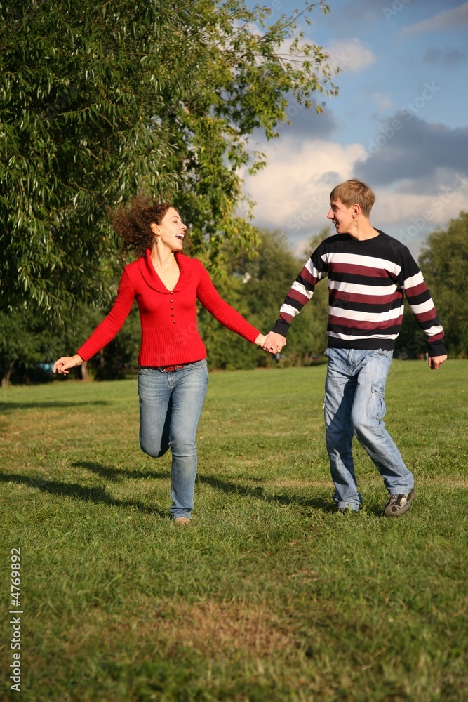 Fototapeta premium happy couple running on the meadow