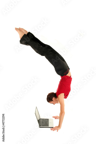 Fototapeta Woman doing handstand and using laptop