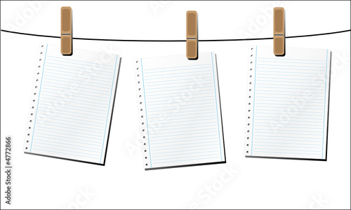 Blank sheets of paper, hanging from a wire. 