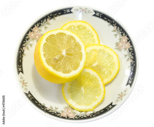 Sliced Lemon on a white plate isolated on white background