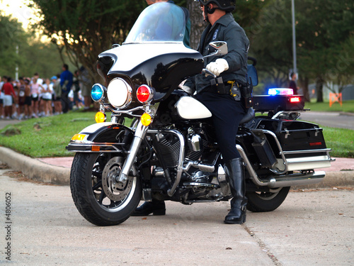 Fototapeta Naklejka Na Ścianę i Meble -  Police officer sitting on Motorcycle  - side view