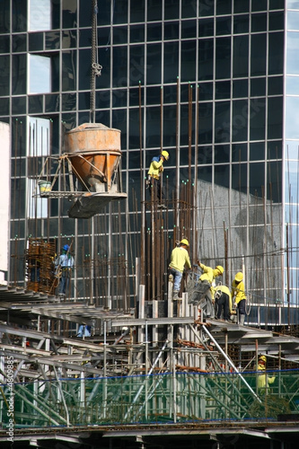 building construction site with cement bucket  and workers