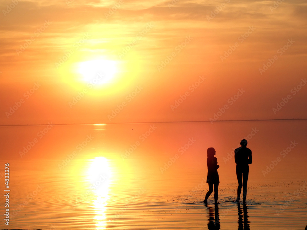 A black silhouette of a children on a sunset