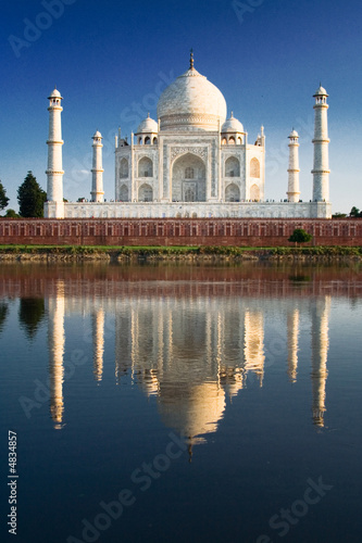 Taj Mahal reflected in river at twilight
