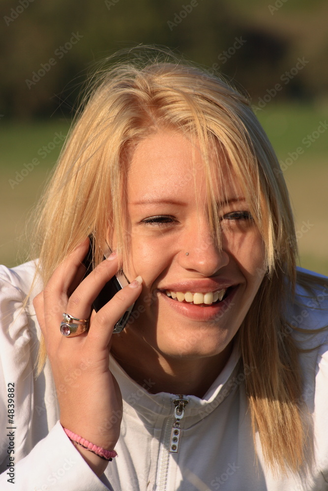 Young woman laughing on a mobile phone Young woman laughing on a mobile phone