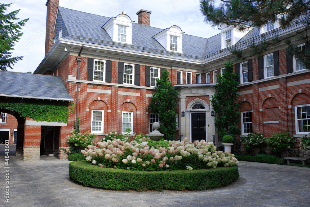 Large house with hydrangea in circular driveway Large house with hydrangea in circular driveway