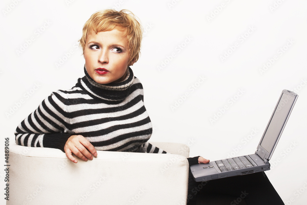 Nice blondgirl sitting on the chair with laptop Nice blondgirl sitting on the chair with laptop