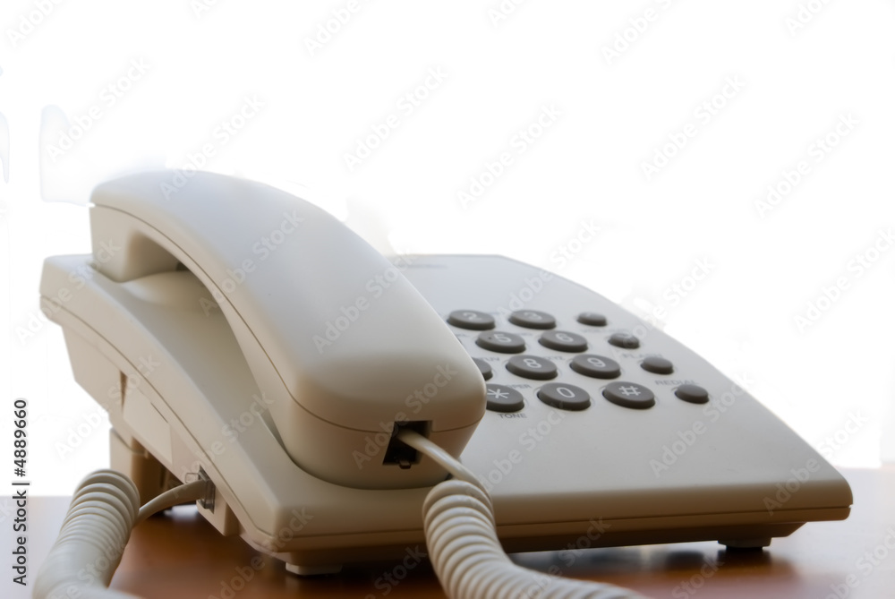 Grey office telephone on the table isolated over white Grey office telephone on the table isolated over white