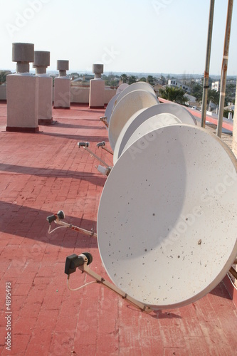 Roof with several satelites in line photo