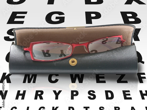 Eyeglasses in case with reflection of eye chart