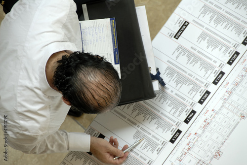 Methodical Visitor Examining The Floor Plan