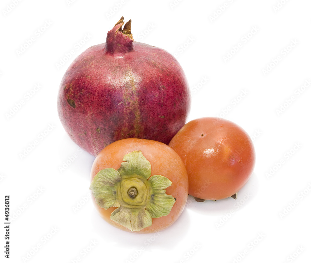 Pomegranate and date-plums isolated with white background Pomegranate and date-plums isolated with white background