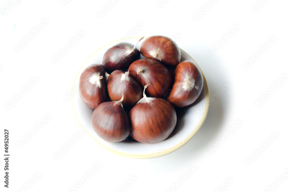 Chestnut in a little soup plate isolated on white background Chestnut in a little soup plate isolated on white background