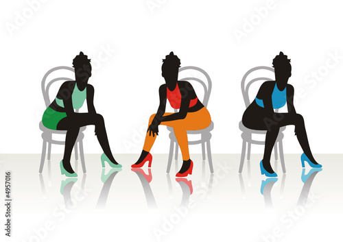 The beautiful girls sits on a chair