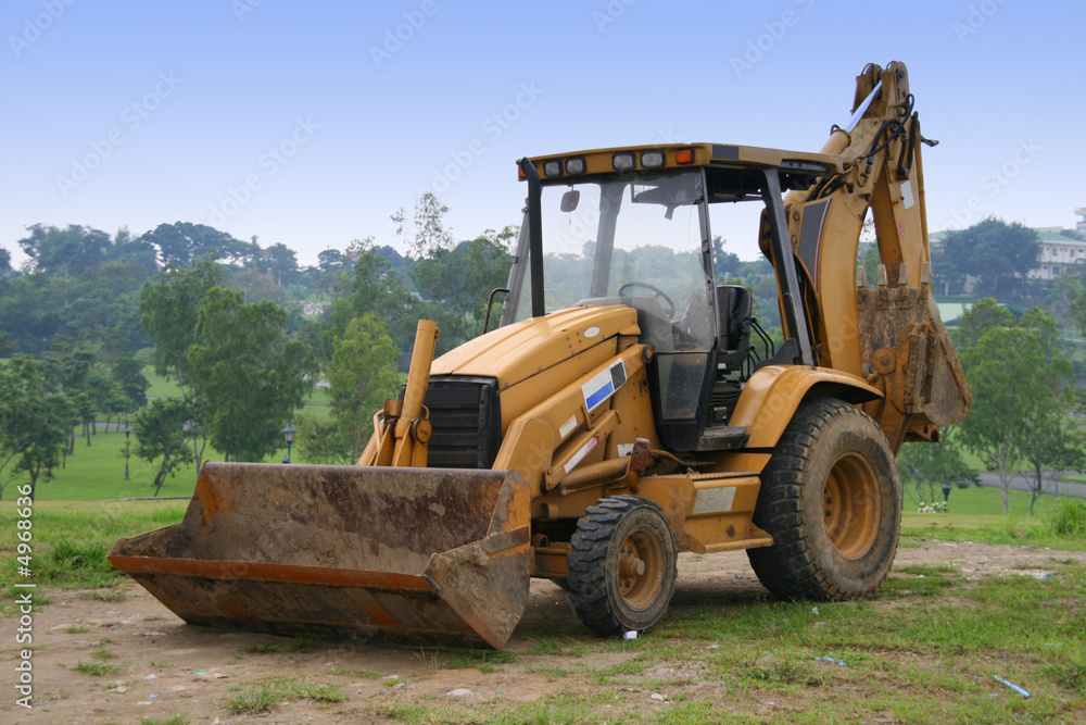 orange power shovel parked on an open field orange power shovel parked on an open field