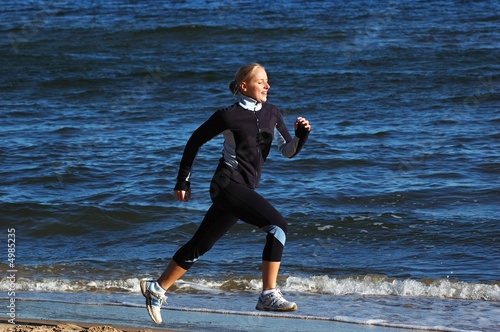 Young woman running on the beach