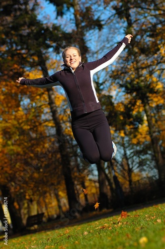 Young, beautiful woman stretching in the park