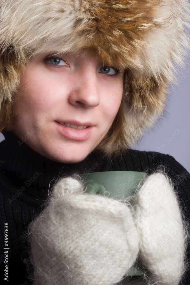 Pretty woman in winter hat with cup Pretty woman in winter hat with cup