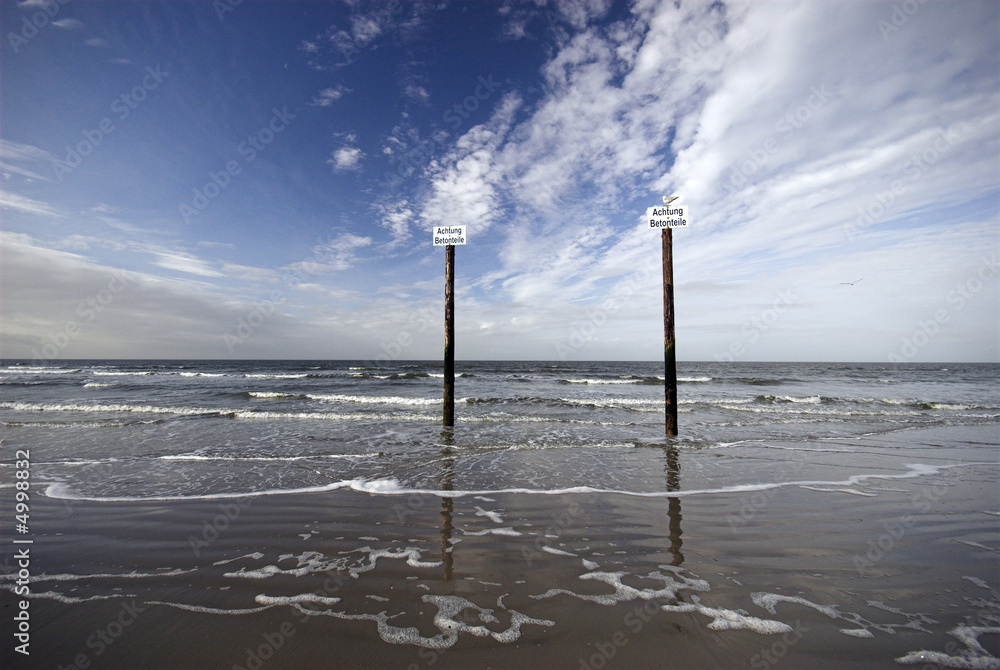 Beautiful North Sea landscape with wooden post warning 