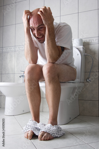 Frustrated man on toilet seat