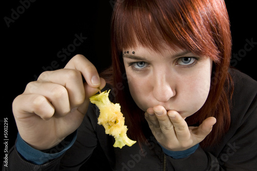 Girl full after eating a delicious apple