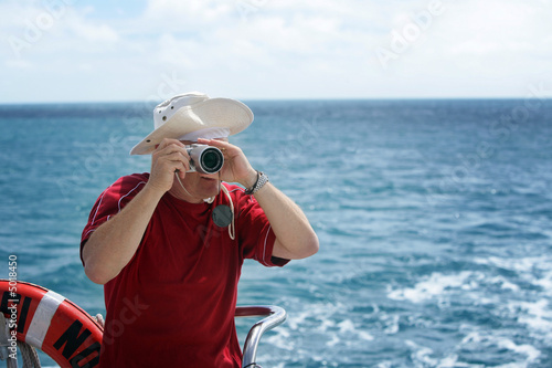 A man taking photos from a boat