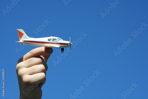 Slika na platnu boy holding toy airplane