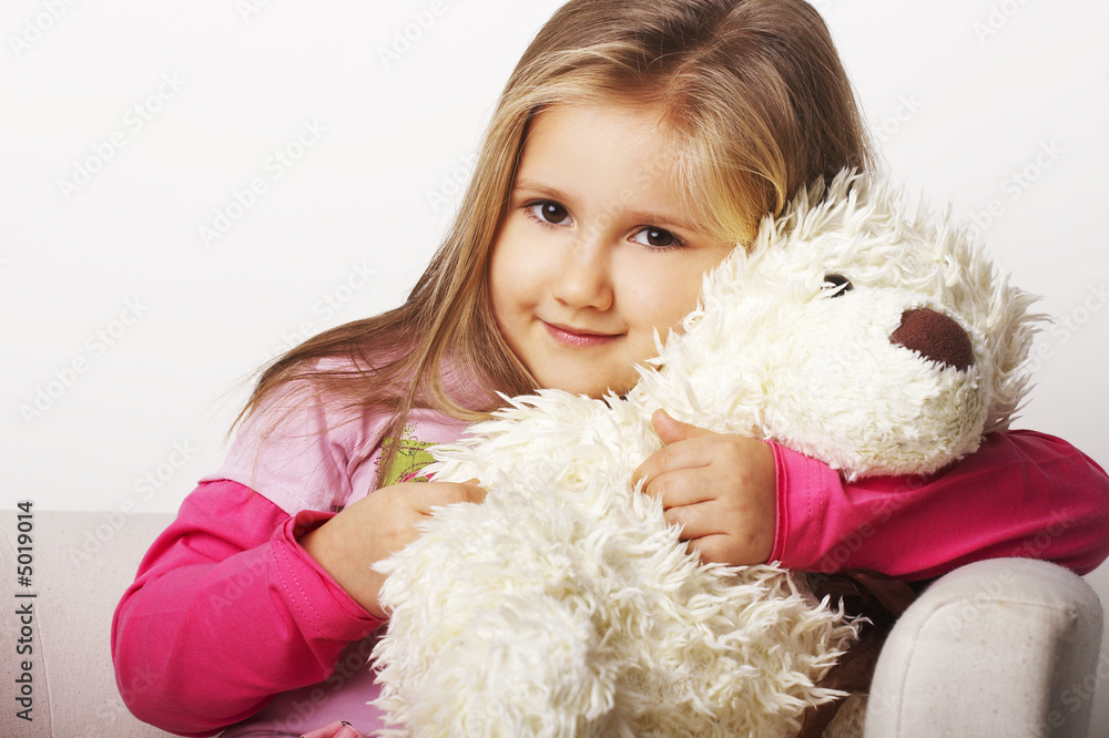 Nice young girl in pink on light background with teddy bear Nice young girl in pink on light background with teddy bear