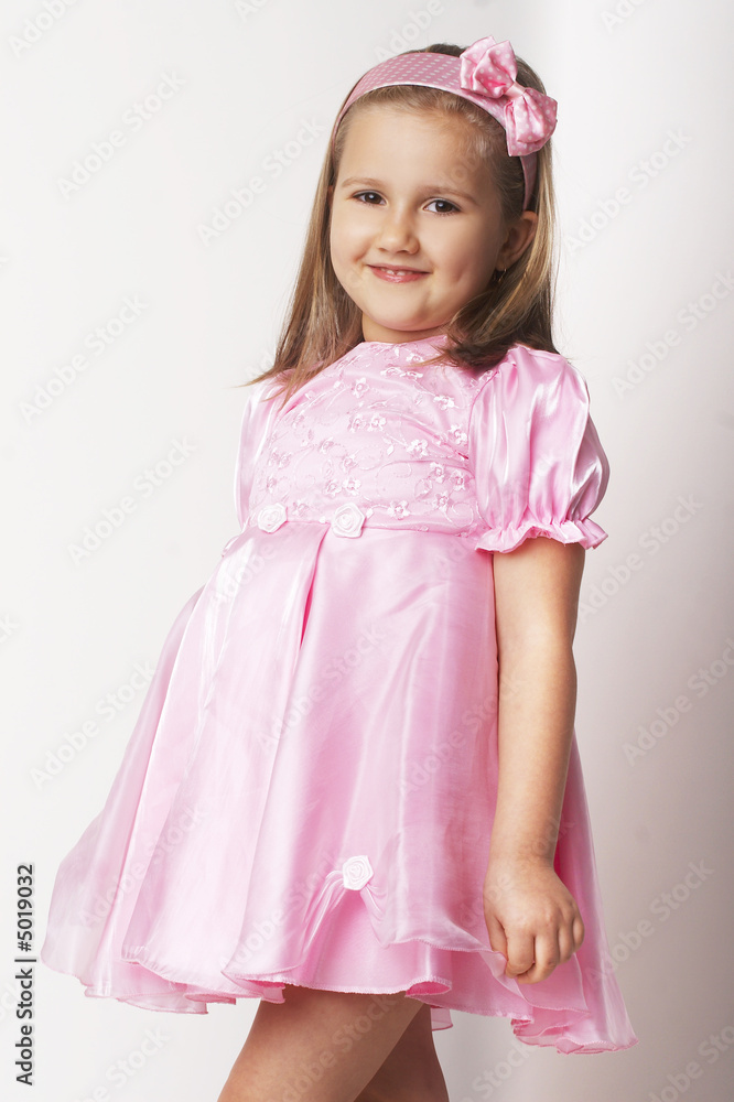 Nice young girl in pink on light background