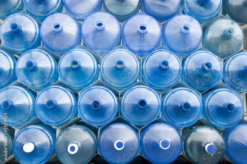 Stack of huge water bottles.