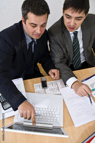 business meeting explanation on a white laptop
