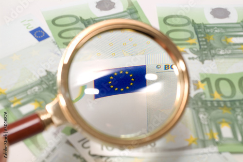 Banknotes through a magnifier.