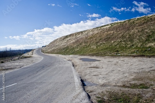 Curved road by a hill
