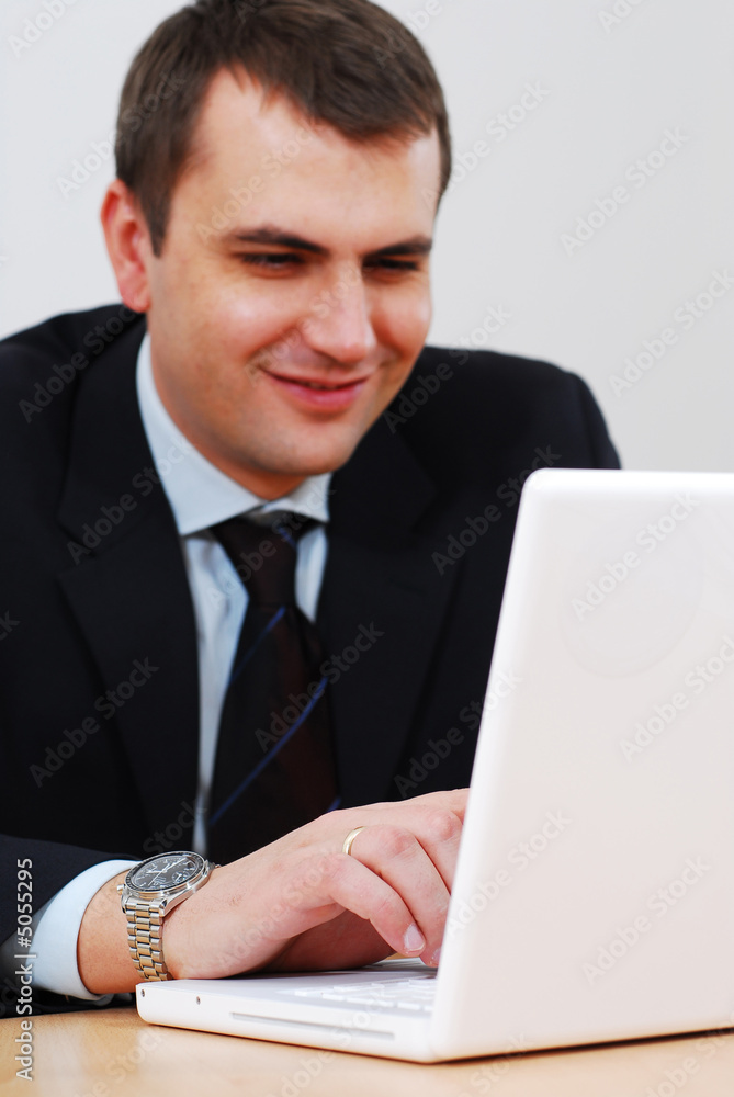 Young businessman working on a lap-top Young businessman working on a lap-top