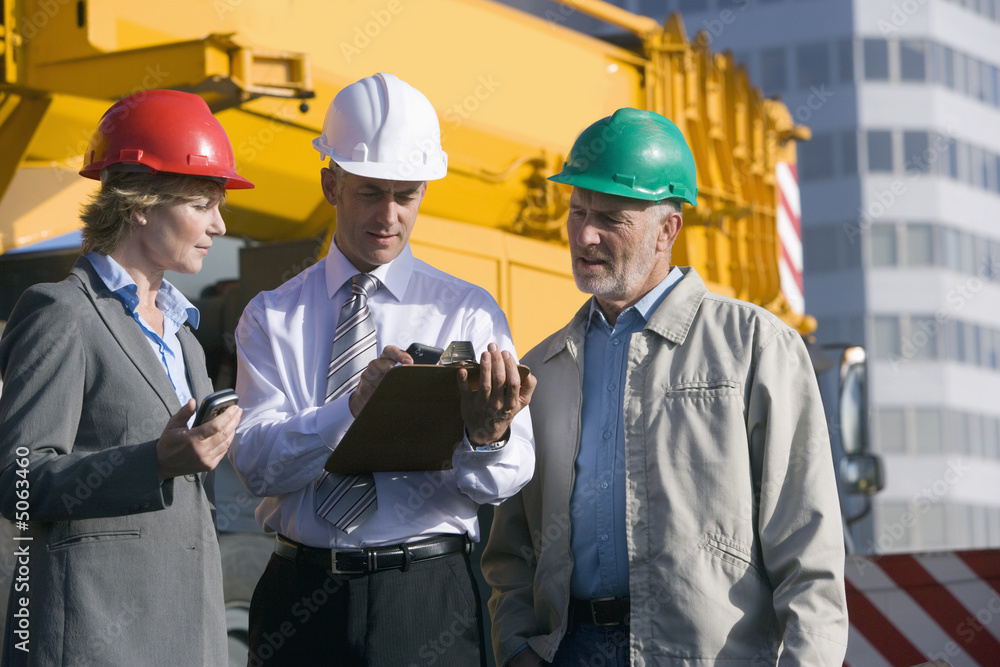 Engineers on location in front of crane Engineers on location in front of crane