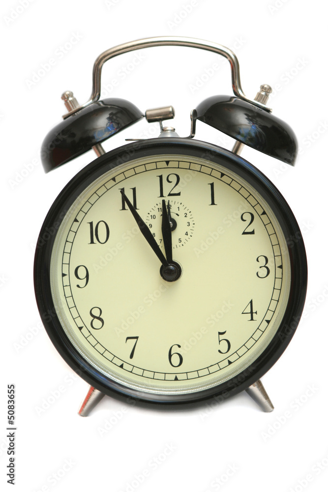 The black alarm clock is isolated on a white background The black alarm clock is isolated on a white background