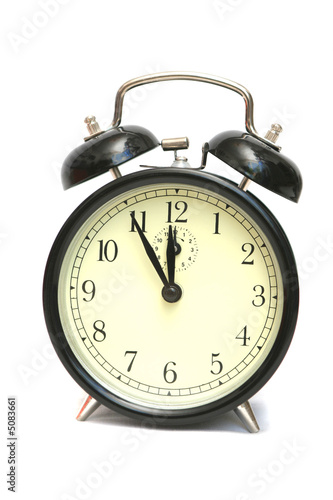 The black alarm clock is isolated on a white background