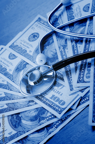 The stethoscope lays on dollars