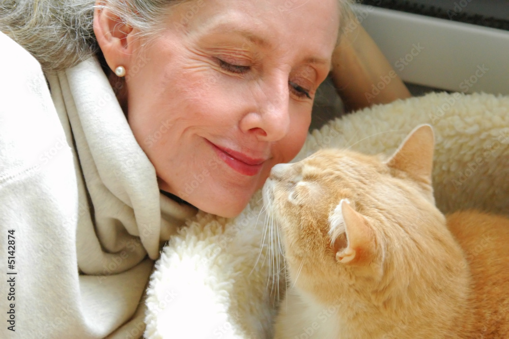 Mature female beauty interacting with her cat. Mature female beauty interacting with her cat.