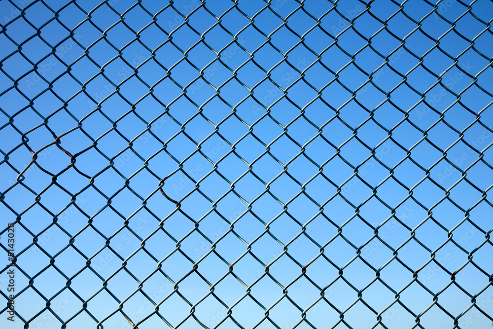 Chain link fence and a blue sky. Chain link fence and a blue sky.