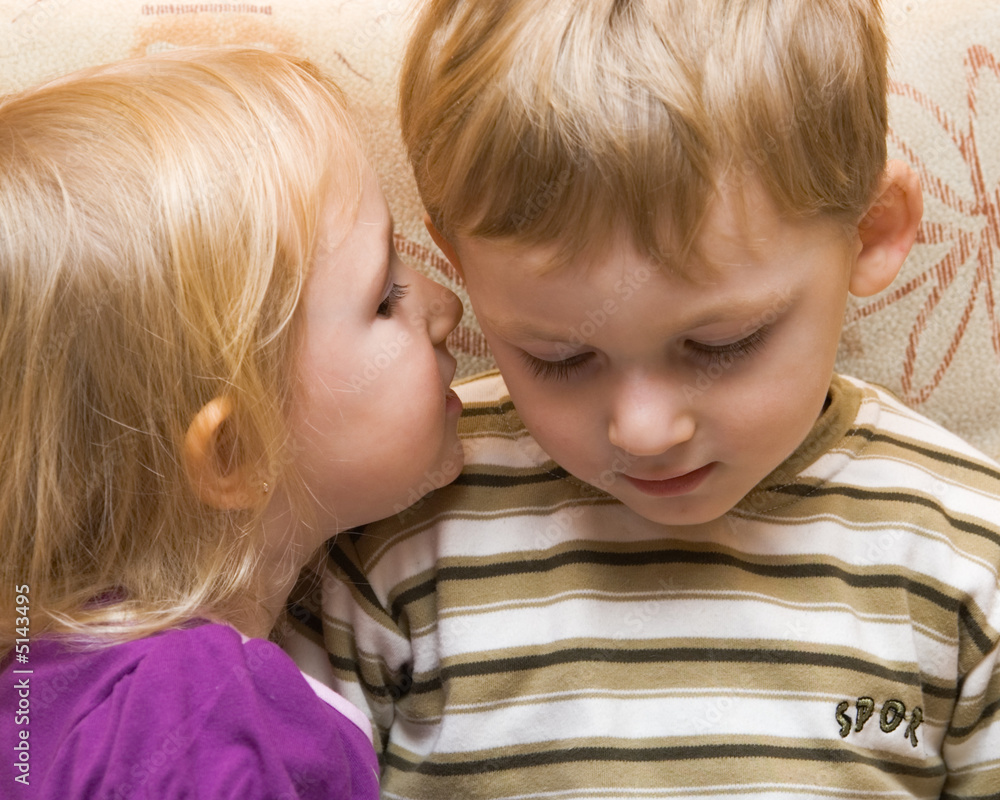 Young boy and girl are whispered Young boy and girl are whispered