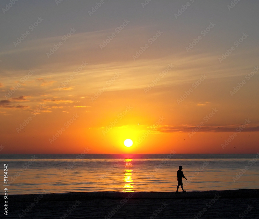 walking on the florida beach at sunset