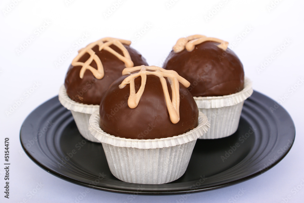 Brandy balls on black plate